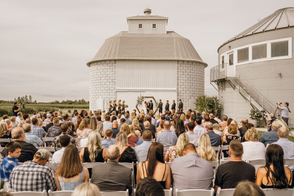 Amber and Drew standing in front of the corn crib during their wedding ceremony.